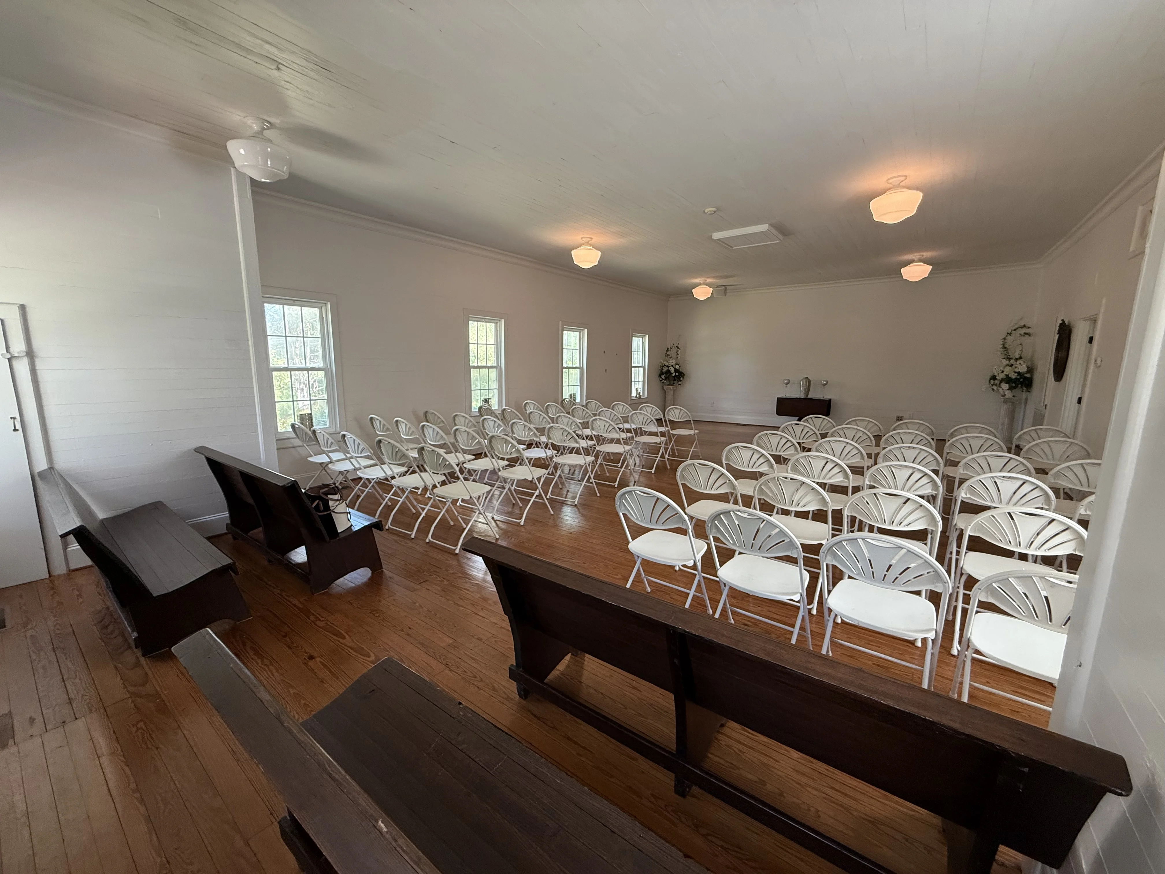 Chapel interior — white chairs and hardwood floors