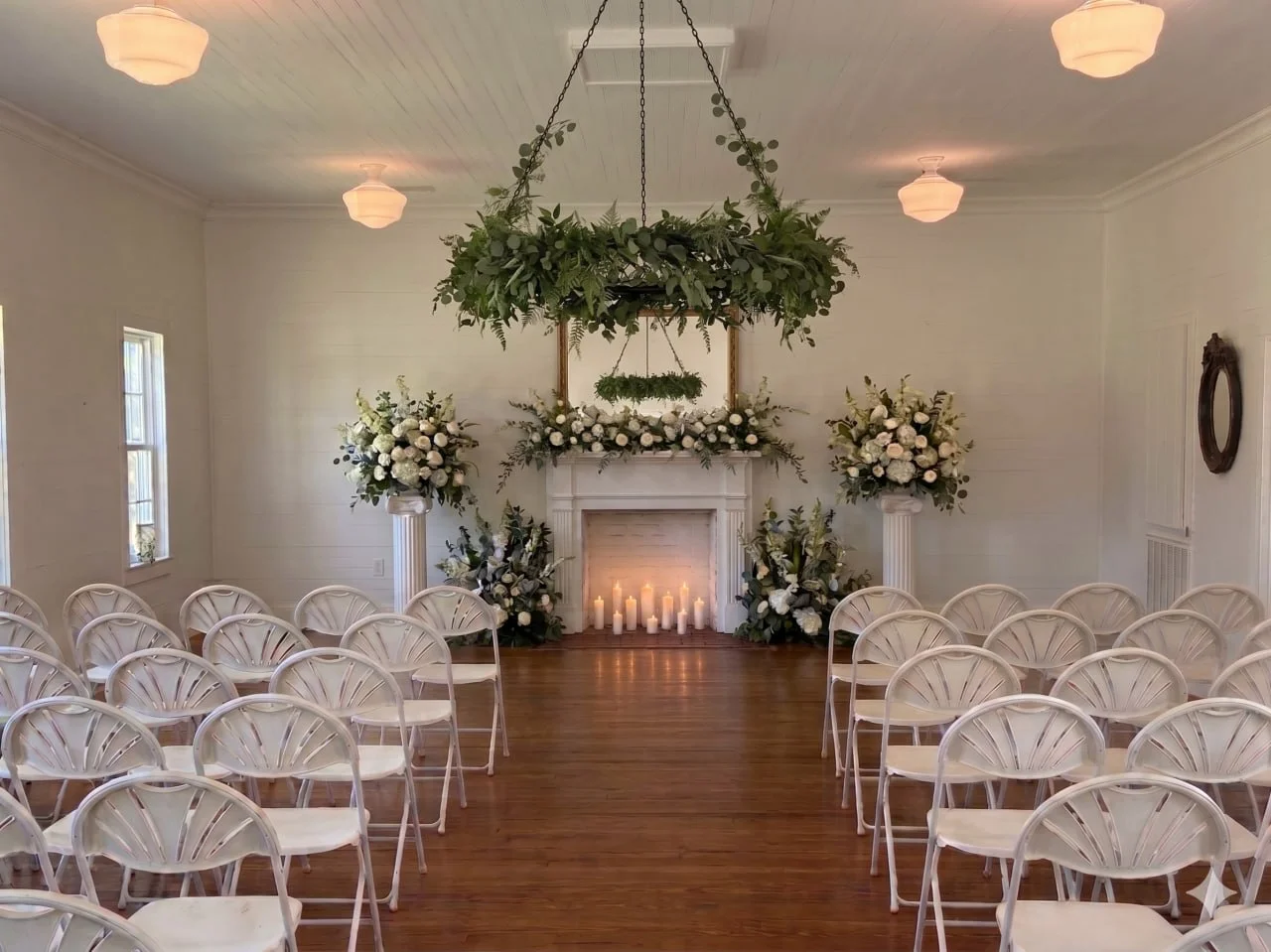 Silver Run Chapel ceremony setup — altar, greenery chandelier, florals